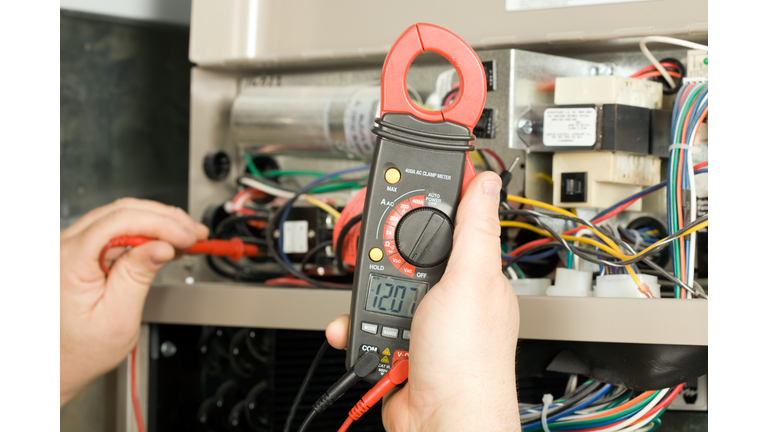 Repairman Checks Voltage on Geothermal HVAC System