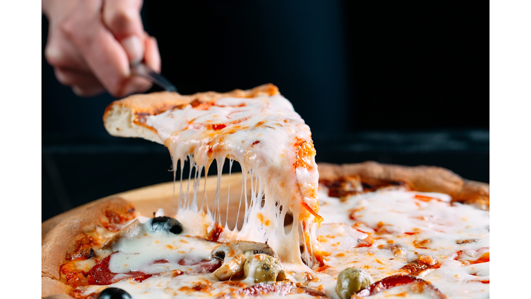 Pizza with very much cheese melting.
