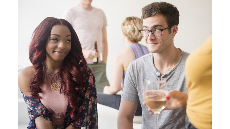 Curious couple flirting at party