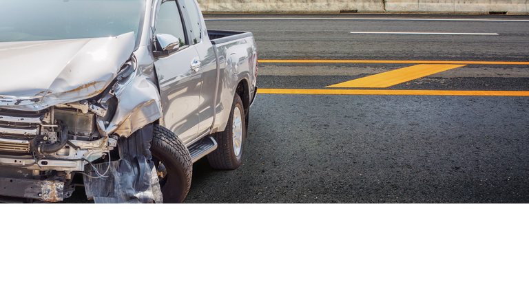 Pickup truck damaged from accident on highway 