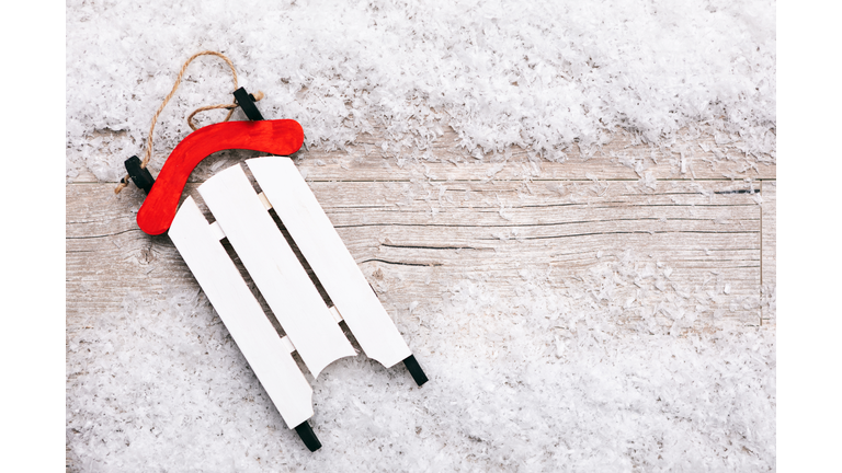 Close-Up Of Toy Sled And Snow On Table