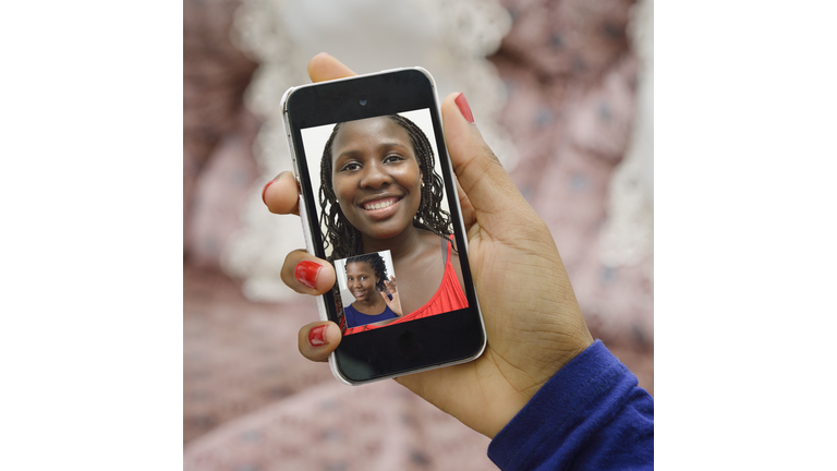 Girl friends connecting using Skype on a phone.