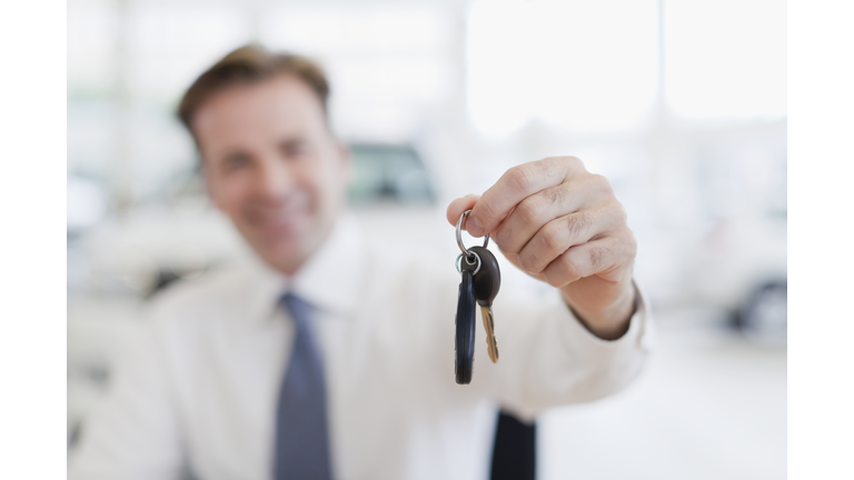 Close up of car salesman holding keys