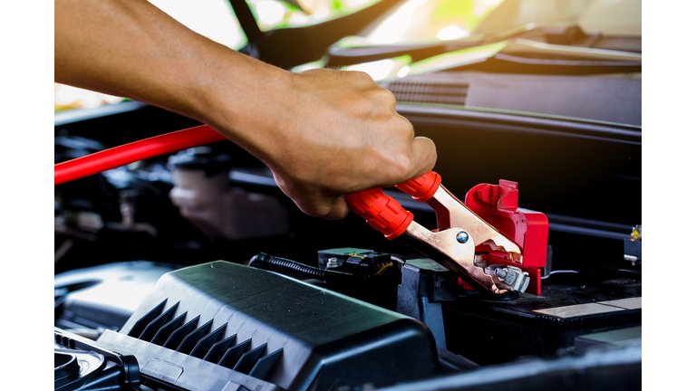 Cropped Hand Of Man Holding Jumper Cable