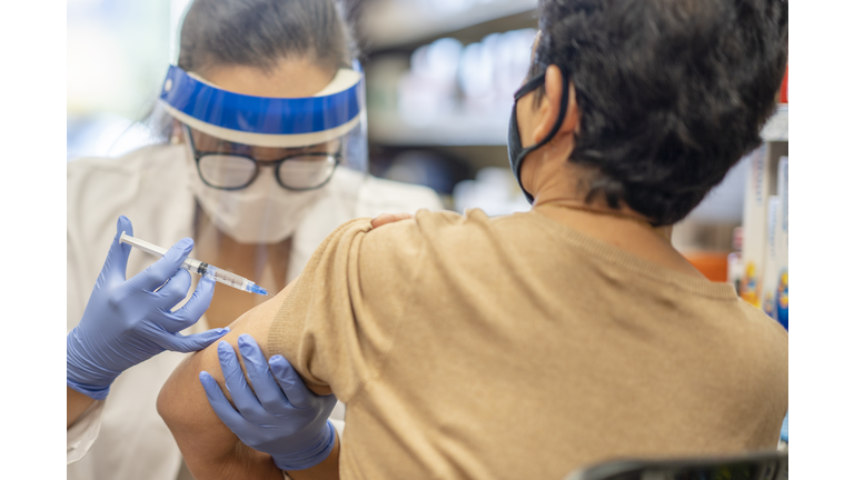 Female pharmacist giving a vaccine