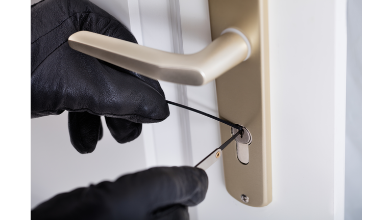 Burglar With Gloves Picking Lock