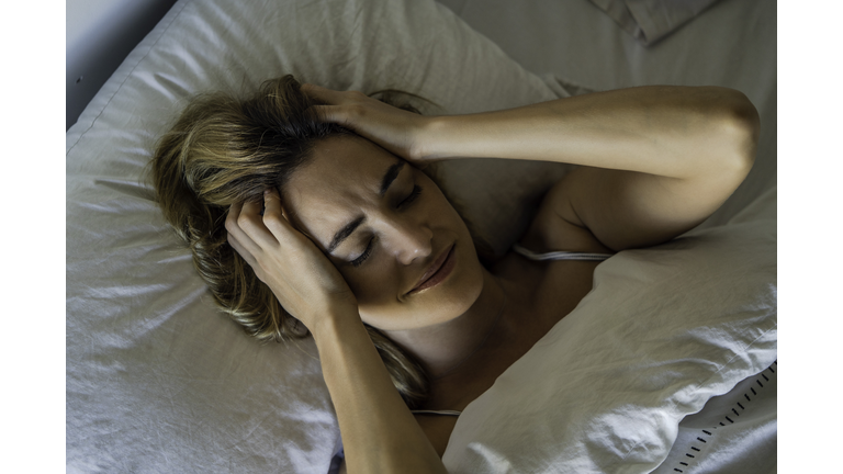 Young woman sleeping on bed