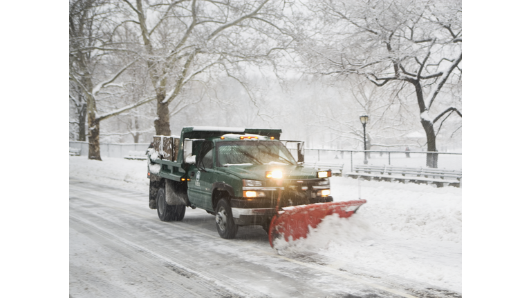 Snow plow truck clearing road