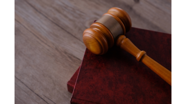 Judge gavel with books on wooden table