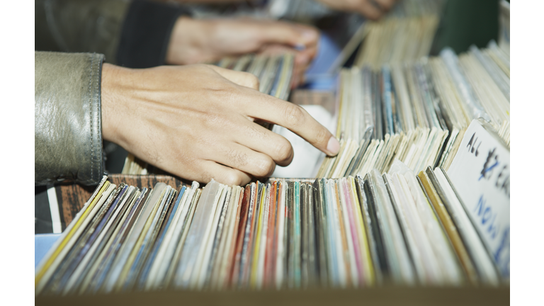 CU on hands searching through vintage records 