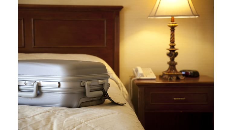 suitcase on bed in hotel room
