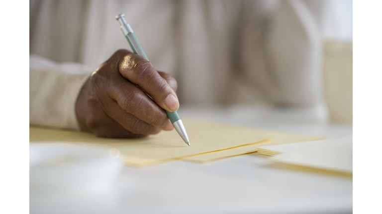 Black woman writing letter