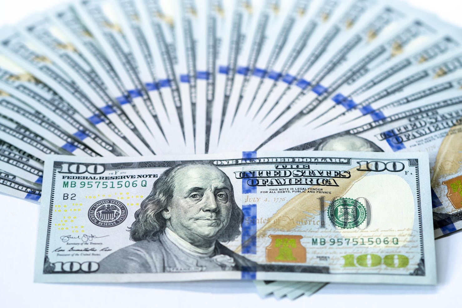 USD 100 dollars banknotes on a group of money isolated on white background