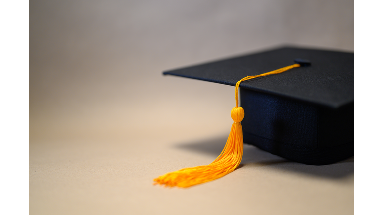 Black Graduation Hat placed on brown paper