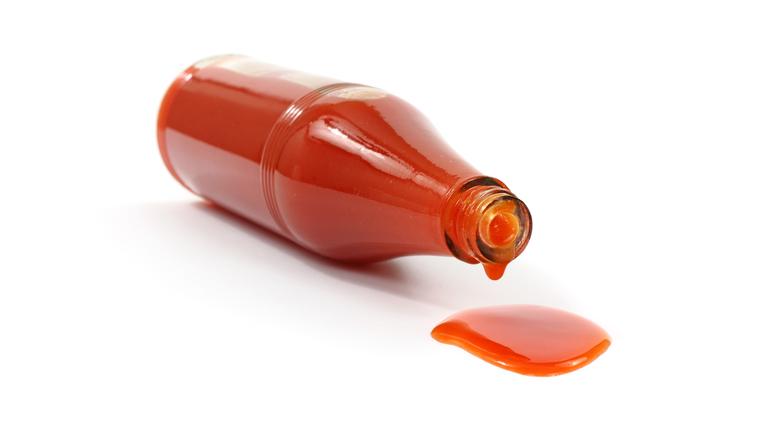 Hot sauce spilling from bottle