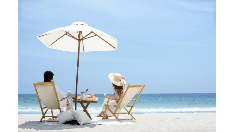 Man and woman who enjoys vacation on beach