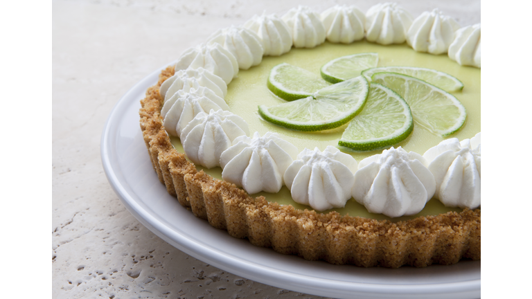 Key Lime Pie With Whipped Cream on a Marble Tabletop.