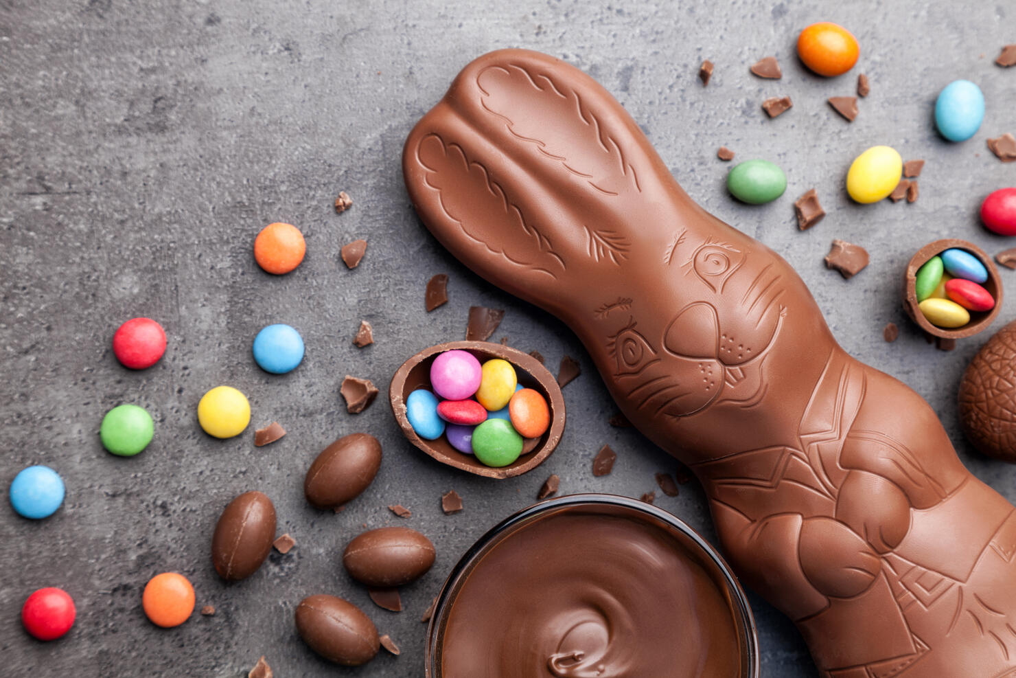 Chocolate Easter bunny and eggs on rustic background