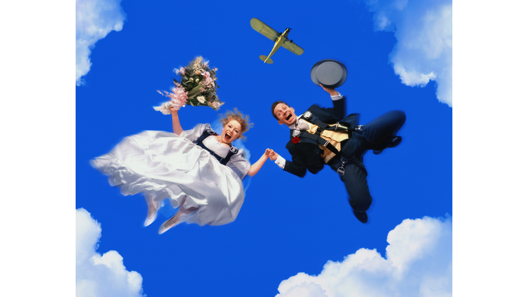 Newly-married couple leaping from plane (Digital Composite)