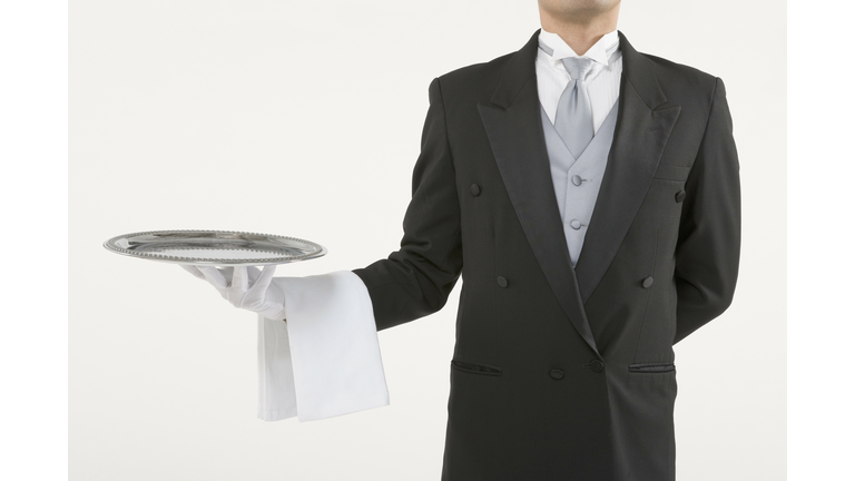 Butler holding an empty silver tray