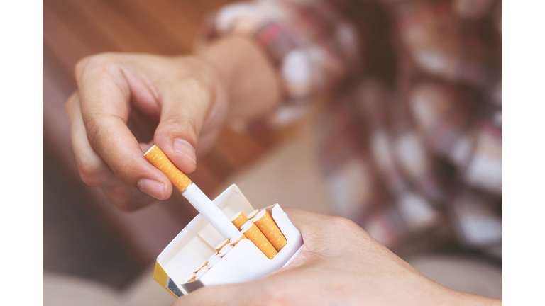 Close-Up Of Person Holding Cigarette Pack