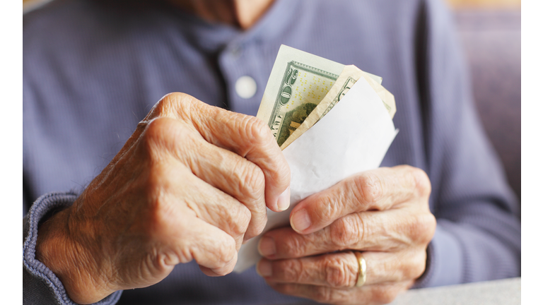 Senior Man Hands Holding Money and Breakfast Bill