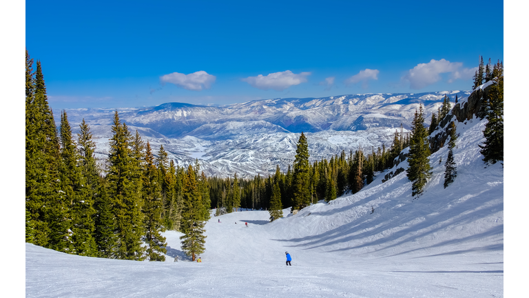 People skiing in Colorado ski resort on clear winter day