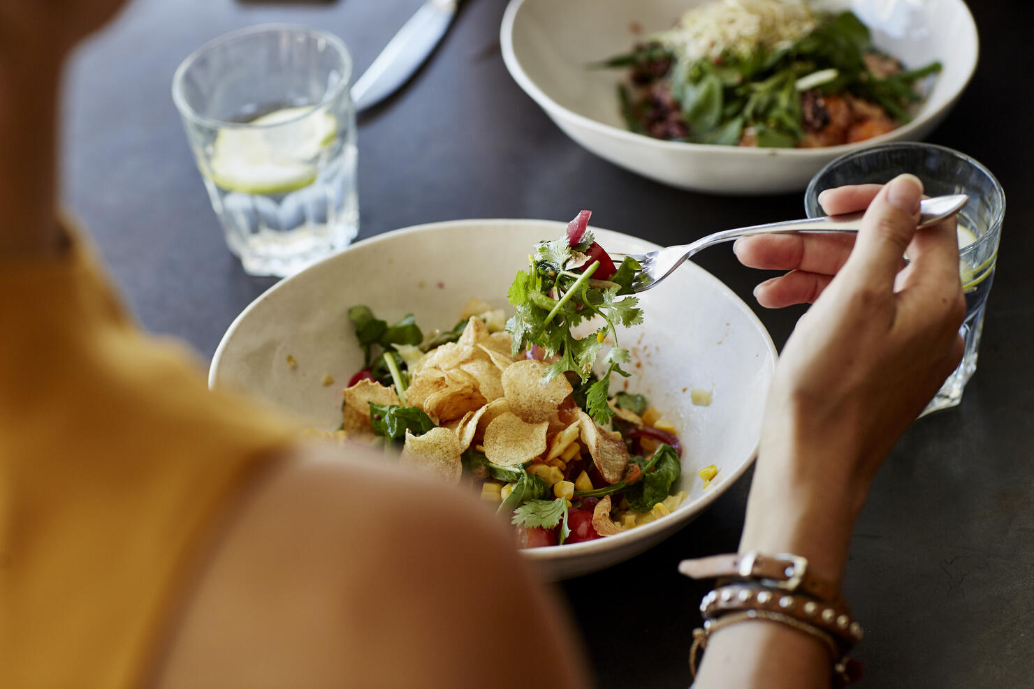 Woman having food at restaurant table