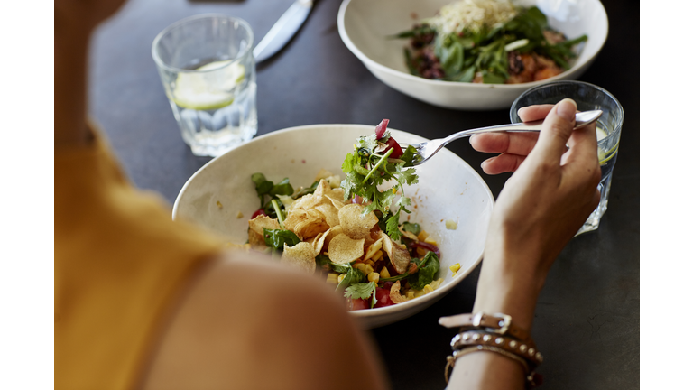 Woman having food at restaurant table