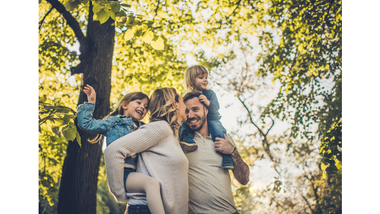 Below view of carefree family having fun in spring day.