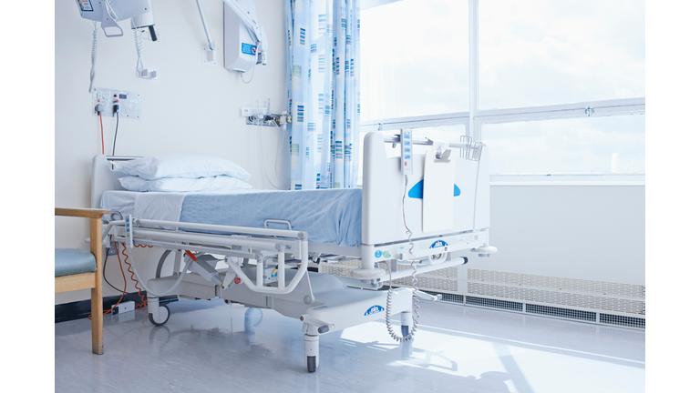 Empty hospital bed on hospital ward