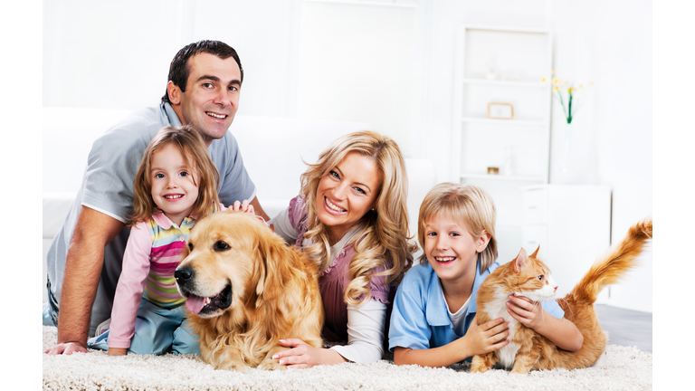 Family with animals sitting on the carpet