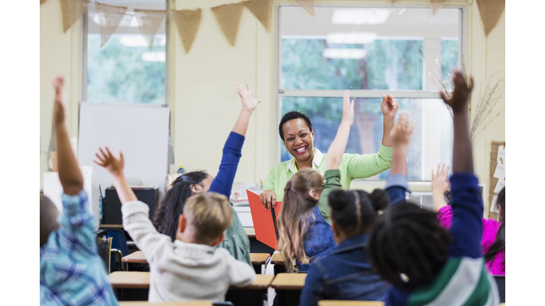 African-American teacher reading to school children