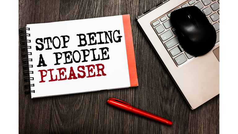 Conceptual hand writing showing Stop Being A People Pleaser. Business photo showcasing Do what you like not things other people want Bluetooth mouse on keyboard words red pen on wooden deck.