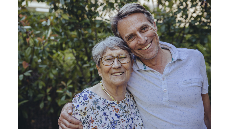 Happy mother and adult son in he garden