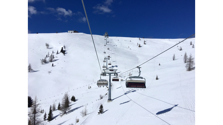 Ski Lift Over Snow Covered Mountains Against Sky