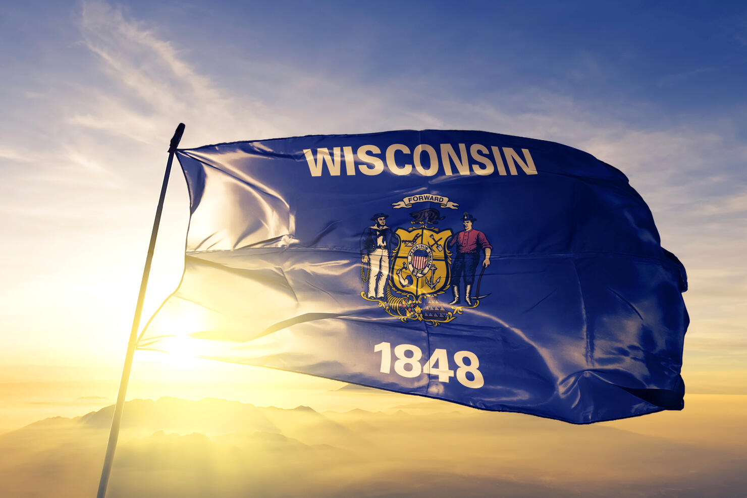 Wisconsin state of United States flag textile cloth fabric waving on the top sunrise mist fog