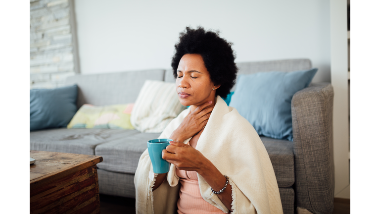 Sick African American woman staying at home