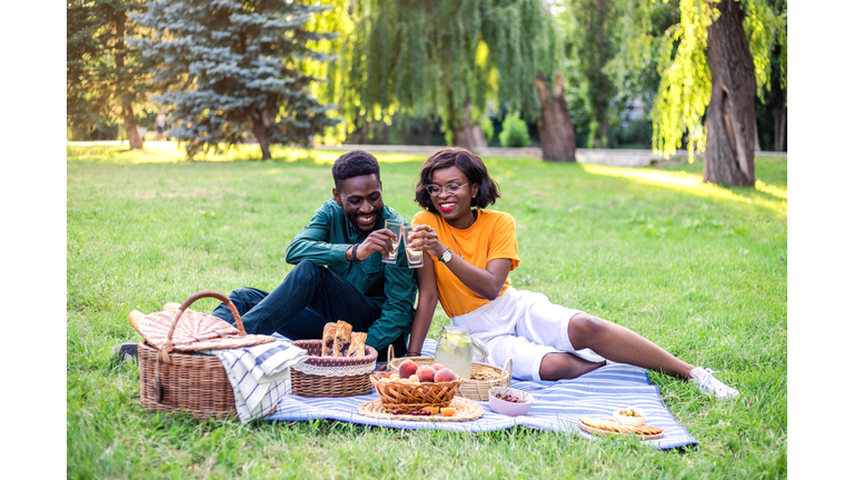 Young black couple on picnic in the park.