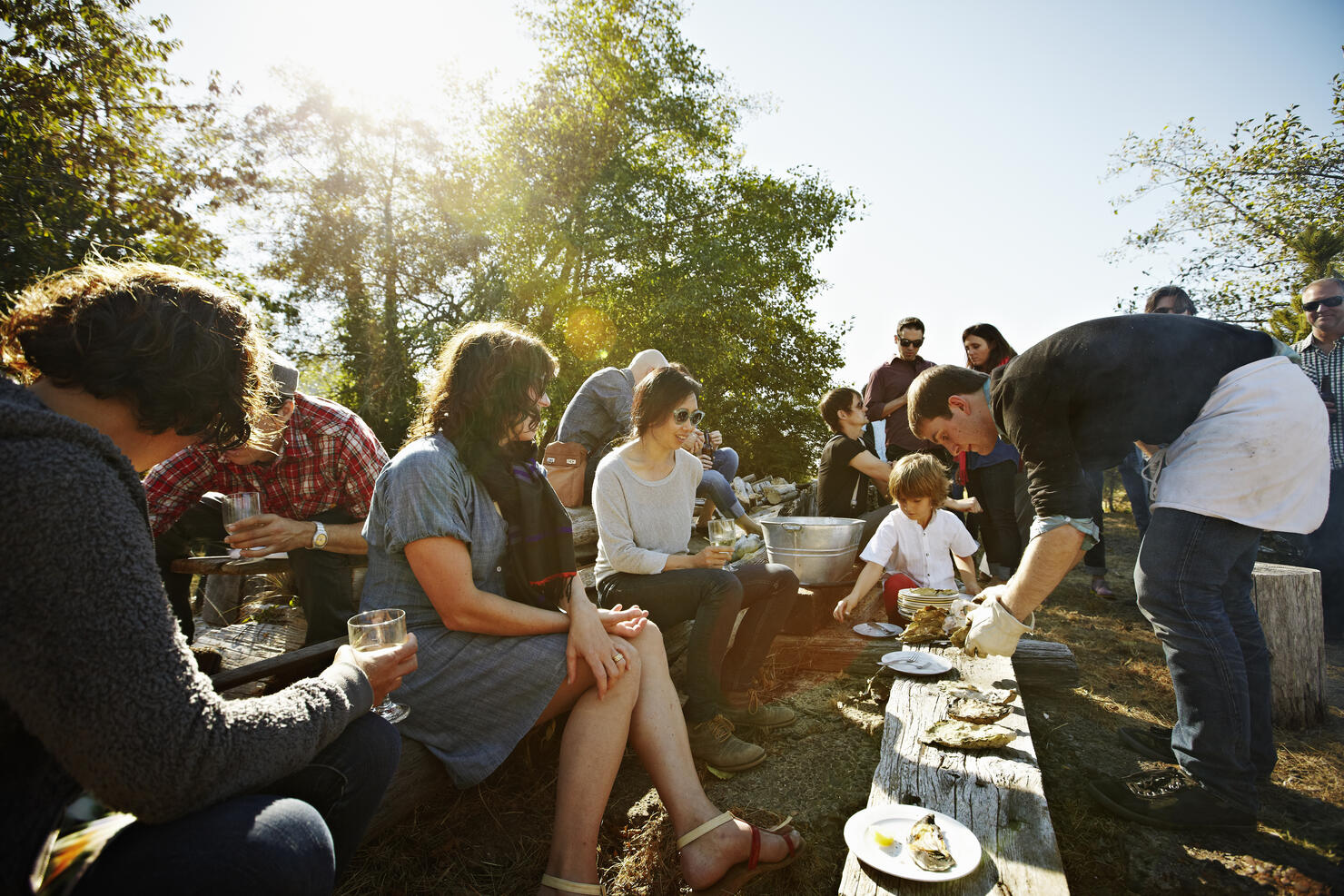Group of friends and family eating oysters outside