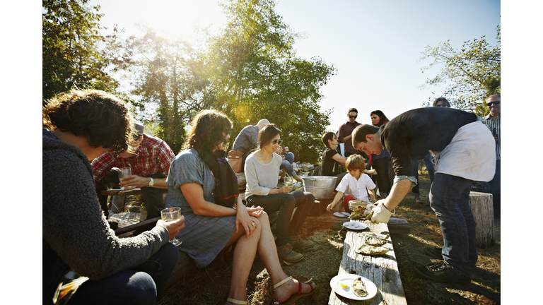 Group of friends and family eating oysters outside
