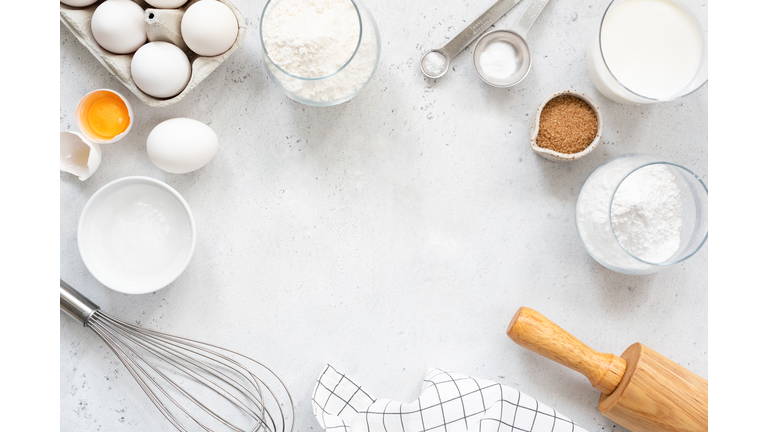 Baking and cooking ingredients on bright grey background