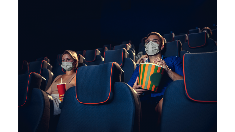 Cinema, movie theatre during quarantine. Coronavirus pandemic safety rules, social distance during movie watching