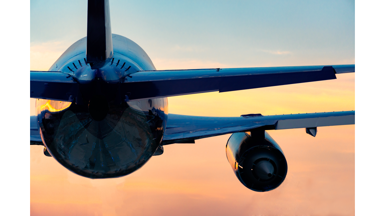 Low Angle View Of Airplane Flying Against Sky During Sunset