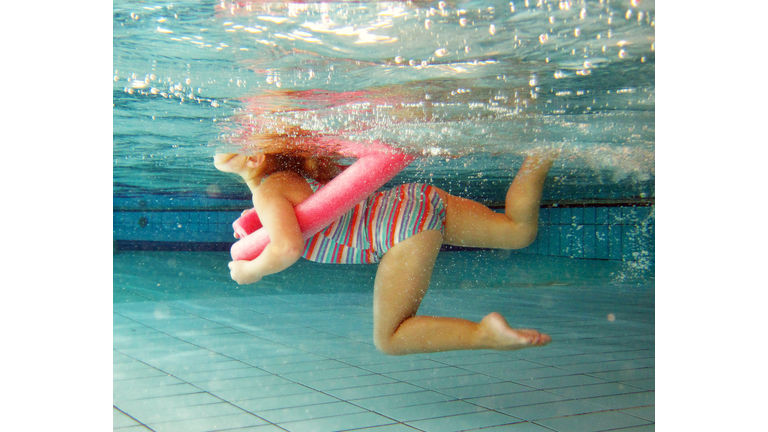 Young Girl Swimming at the Pool