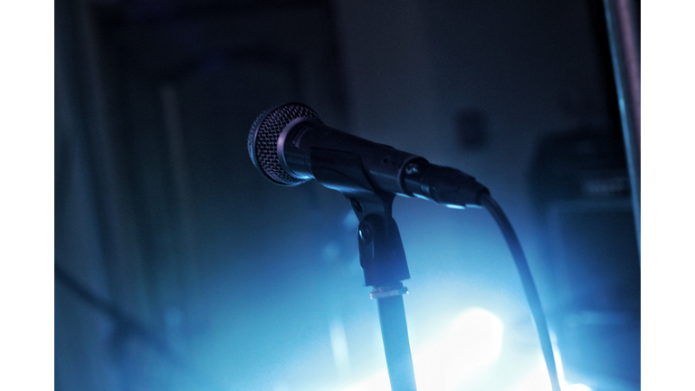 Close-Up Of Microphone Against Bright Light At Concert