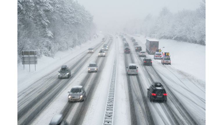 snow covered highway in austria with cars out of focus