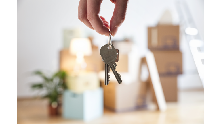 Close-up of woman holding house key in new home