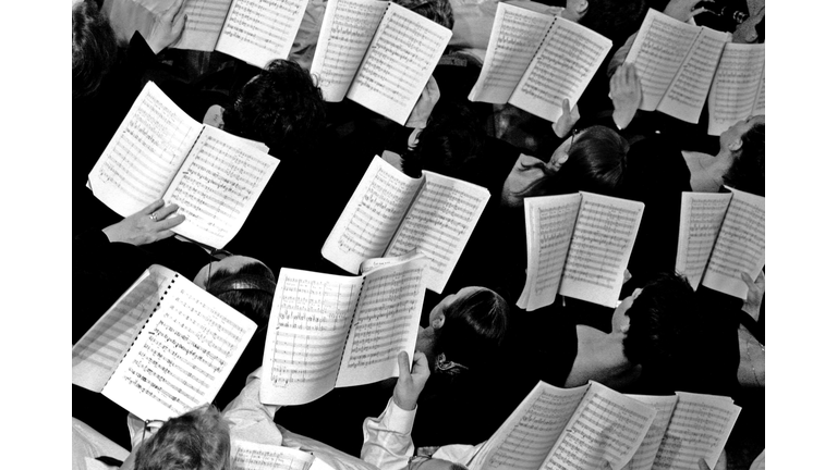 Choir with notes in hands, overhead view