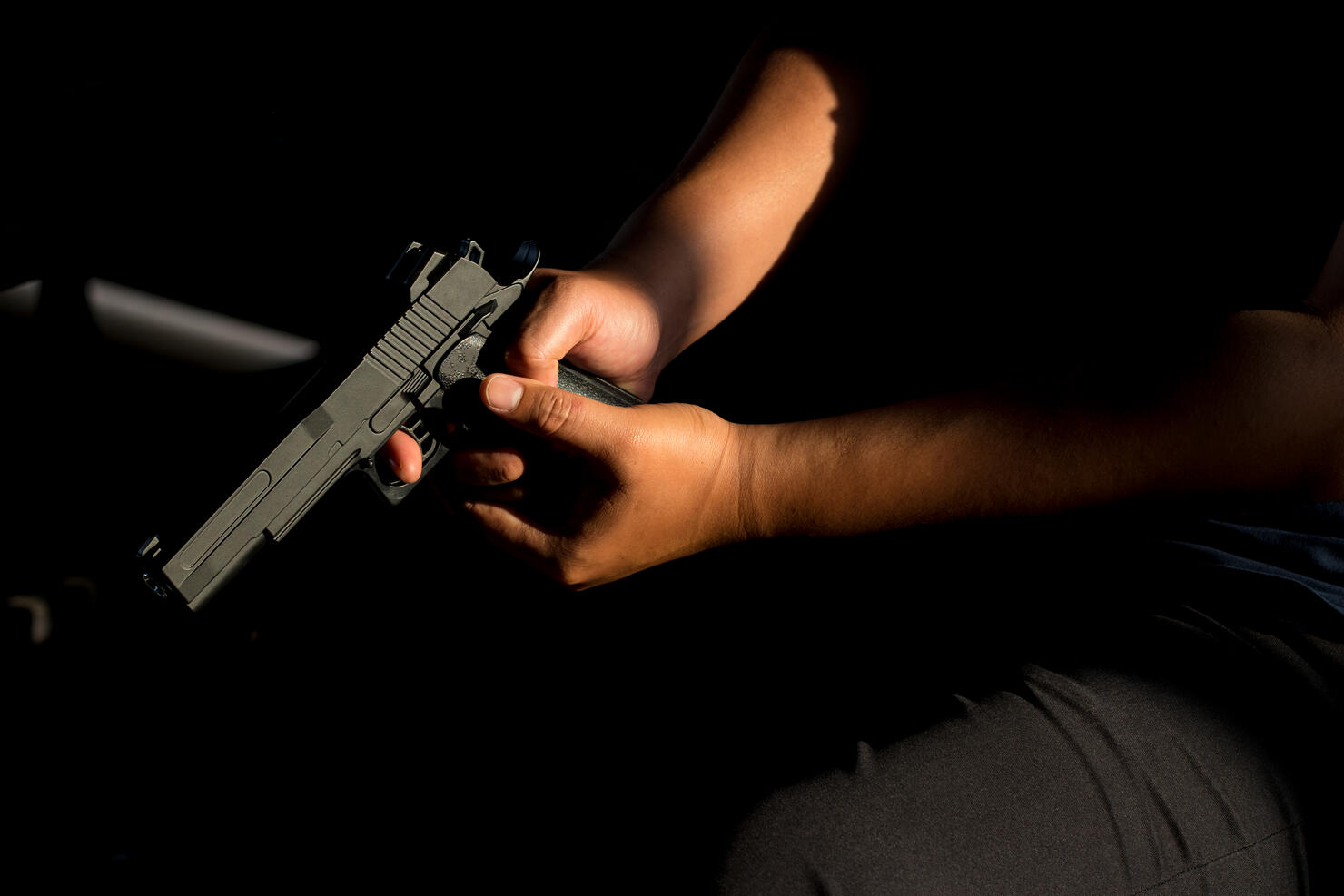 Midsection Of Man Holding Gun